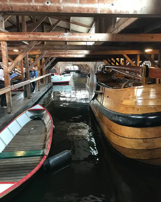 Boats moored inside the wooden auction hall at Broeker Veiling