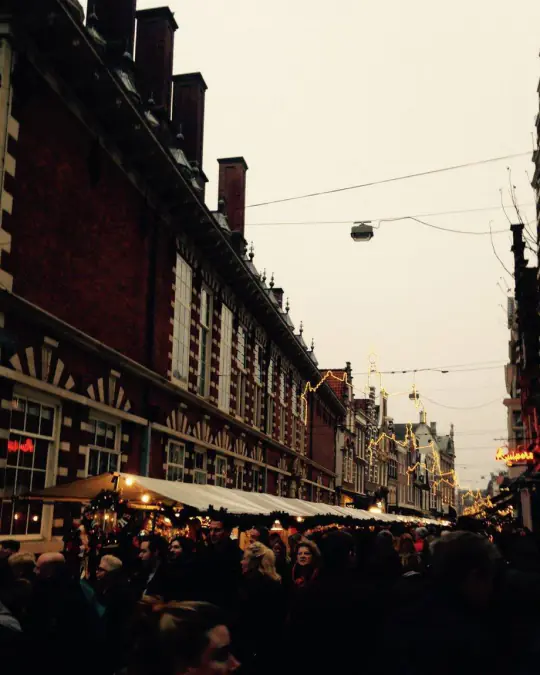 The Christmas market in Haarlem at dusk, with stalls along the main street